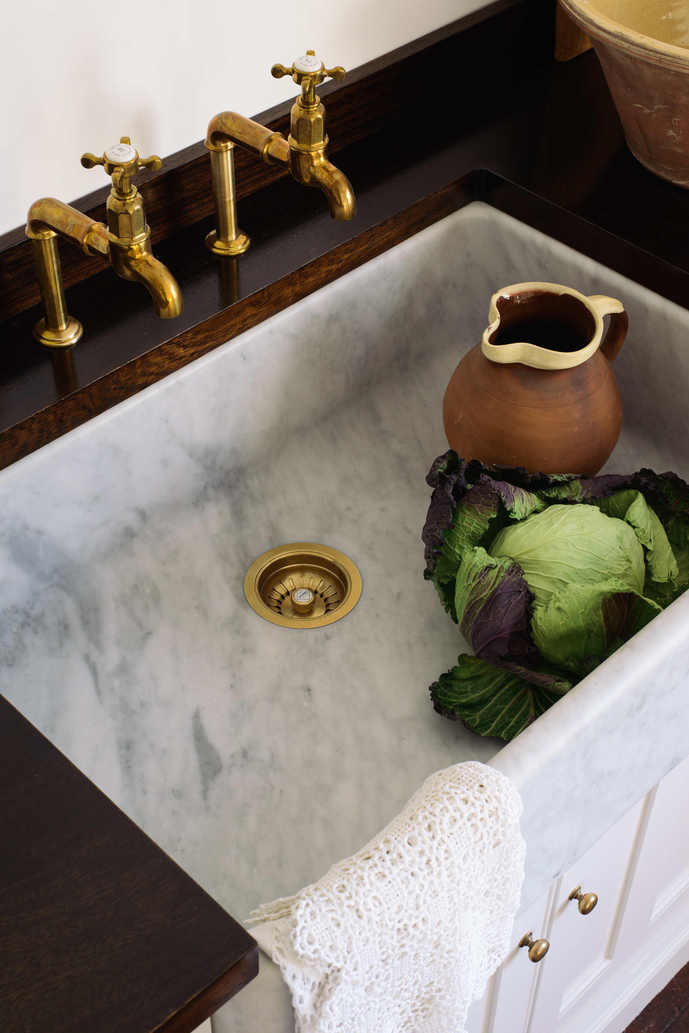 A solid block of Carrara marble is used to make these beautiful sinks. The taps are Perrin and Rowe, in deVOLs aged brass finish exclusive to us.