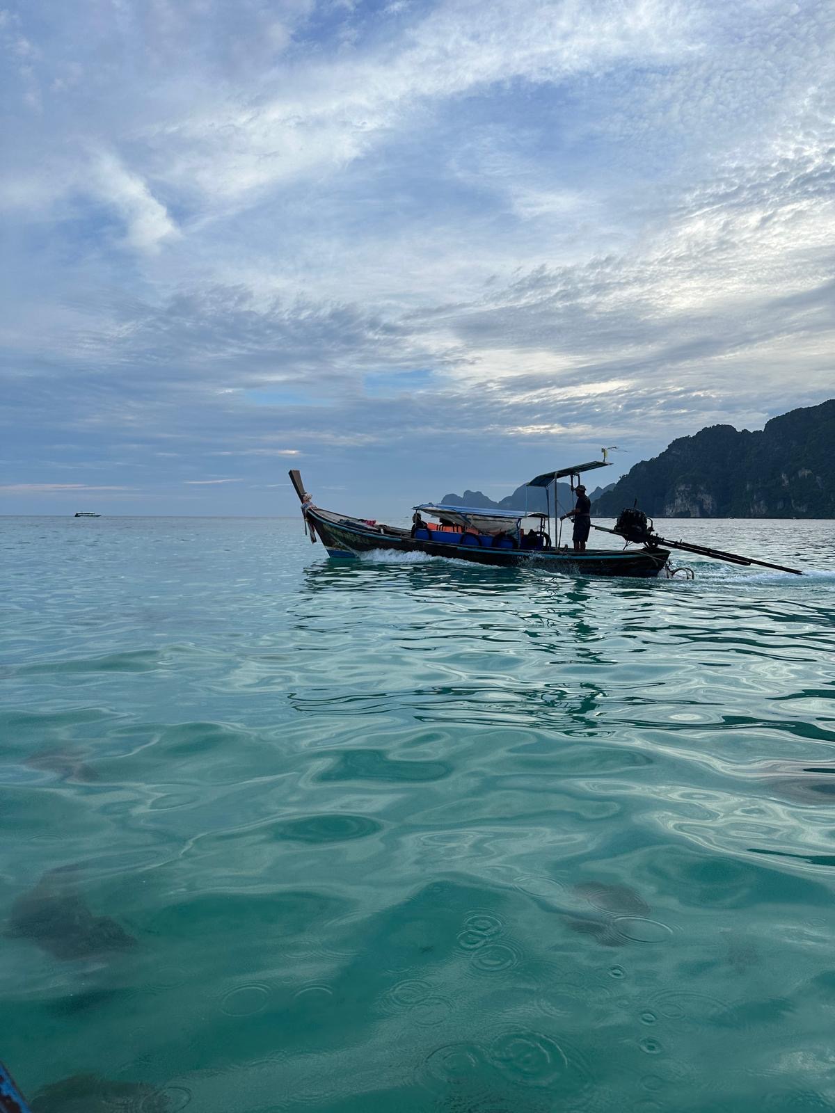 A small boat on a beautifully blue ocean.
