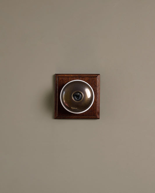 The Dolly Toggle Switch (1 Gang & Mahogany Finish Pattress) - Oxidised Brass with White Base.