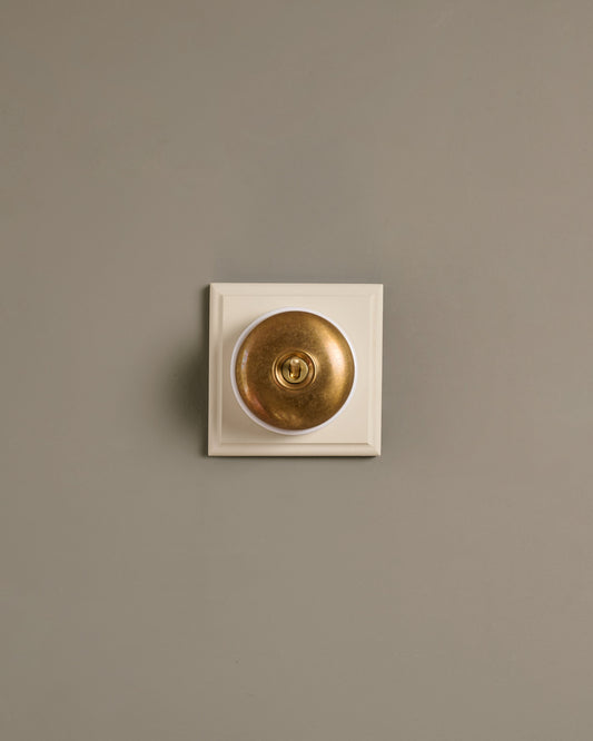 The Dolly Toggle Switch (1 Gang & Primed Maple Pattress) - Aged Brass with White Base.