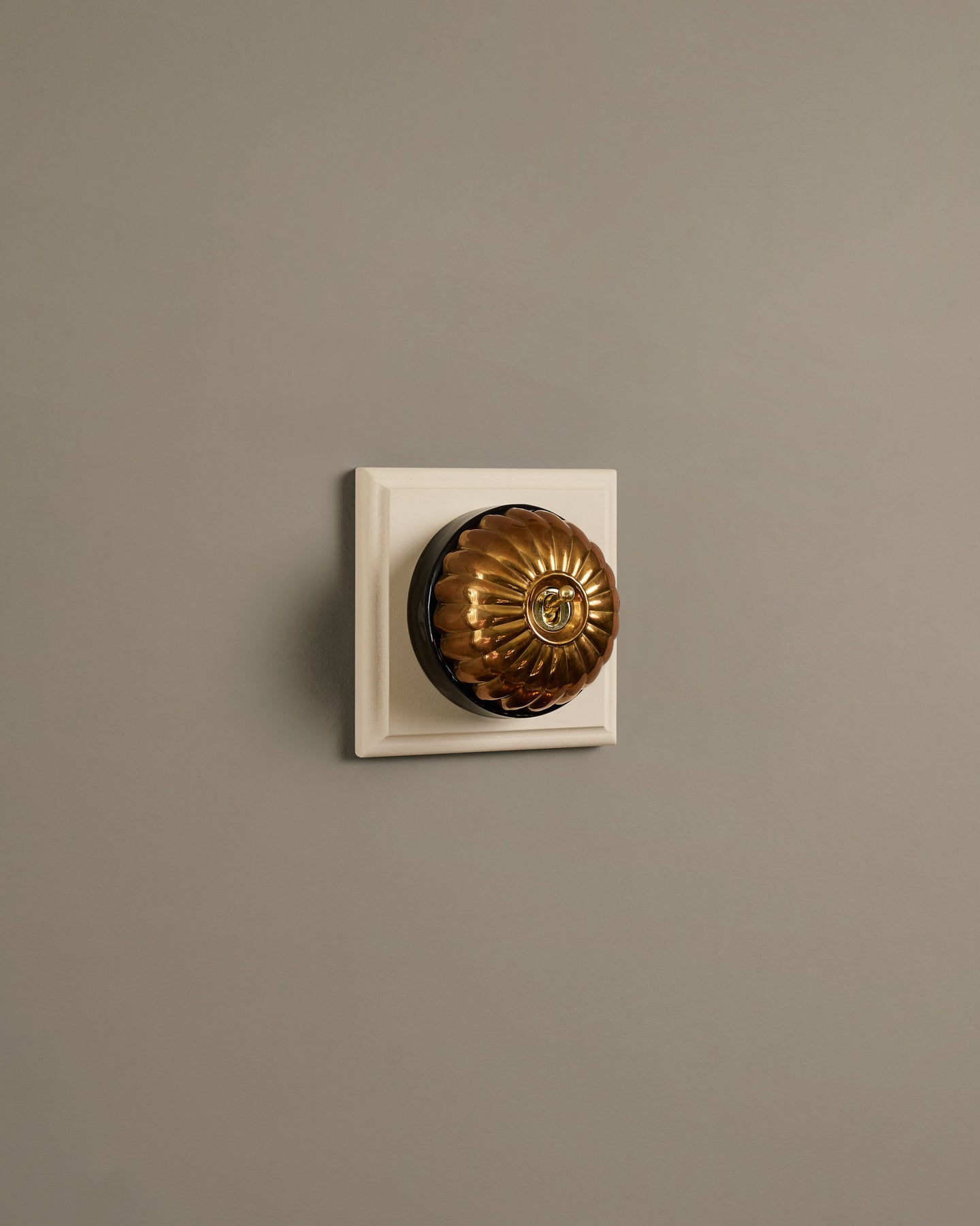 The Jelly Toggle Switch (1 Gang & Primed Maple Pattress) - Heirloom Brass with Black Base.