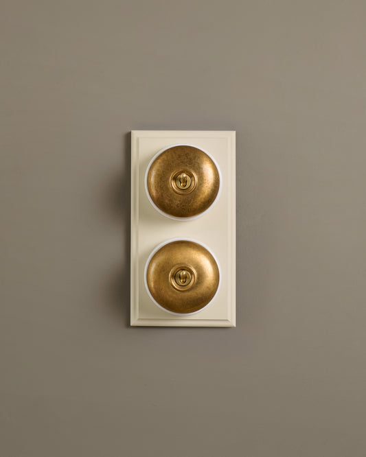 The Dolly Toggle Switch (2 Gang & Primed Maple Pattress) - Aged Brass with White Base.