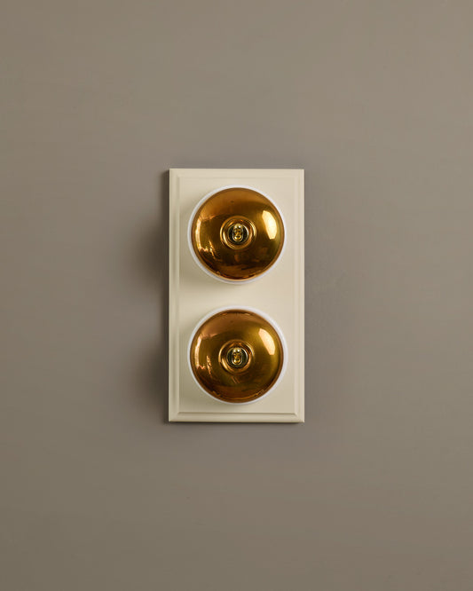 The Dolly Toggle Switch (2 Gang & Primed Maple Pattress) - Heirloom Brass with White Base.