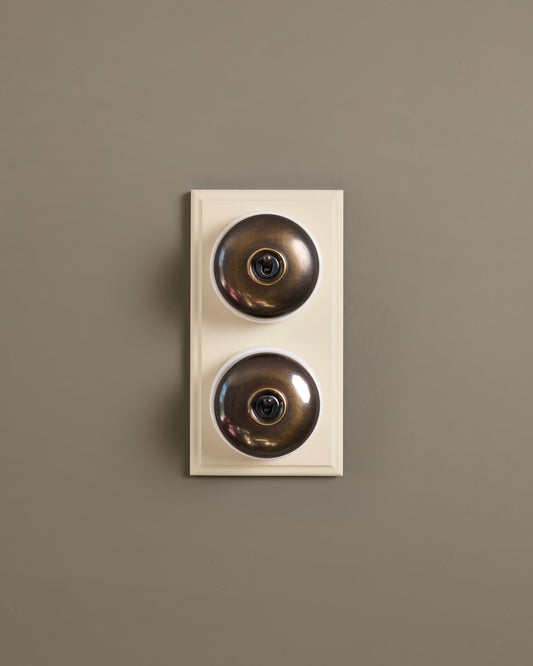 The Dolly Toggle Switch (2 Gang & Primed Maple Pattress) - Oxidised Brass with White Base.