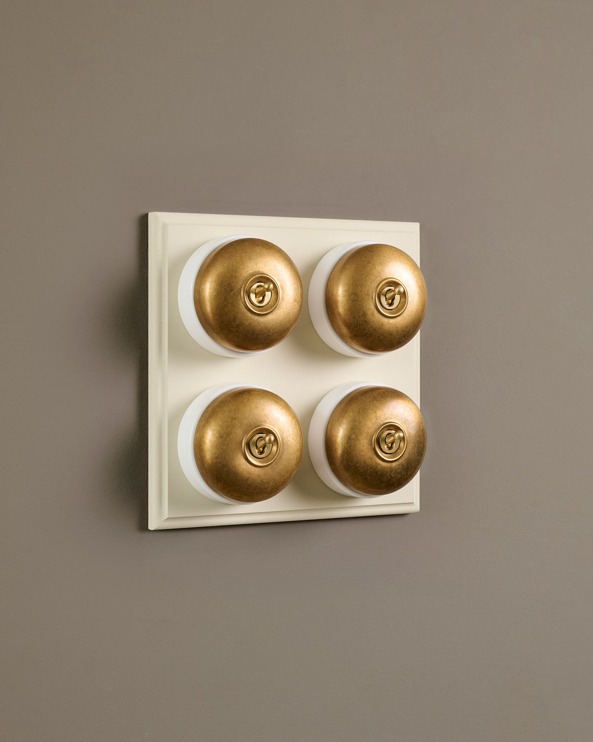 The Dolly Toggle Switch (4 Gang Bank & Primed Maple Pattress) - Aged Brass with White Base. TEST