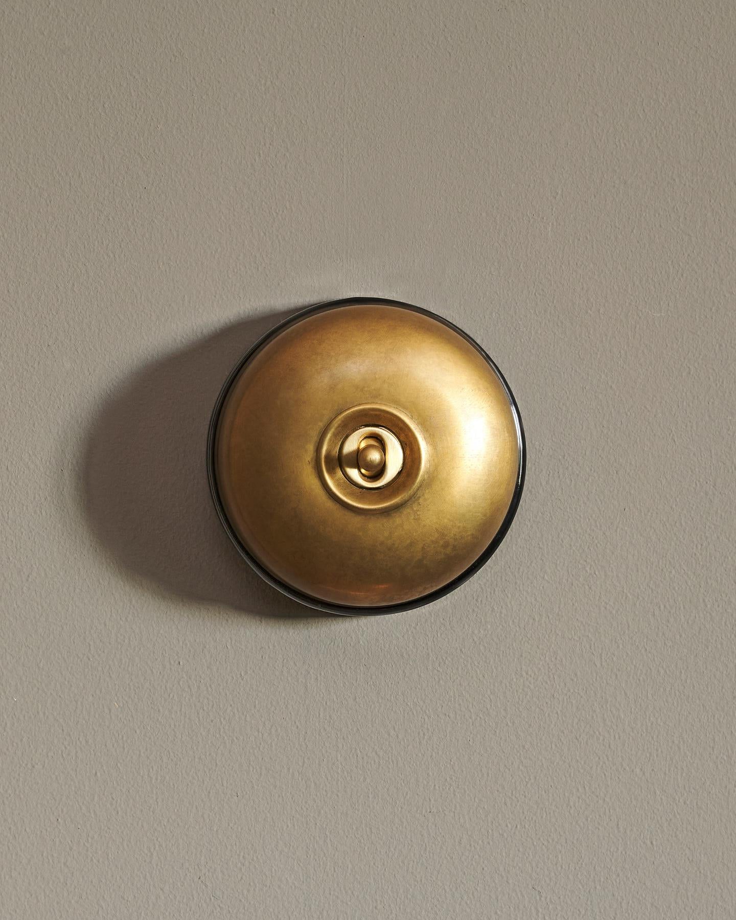 The Dolly Toggle Switch - Aged Brass, Black Base, Retract to Centre