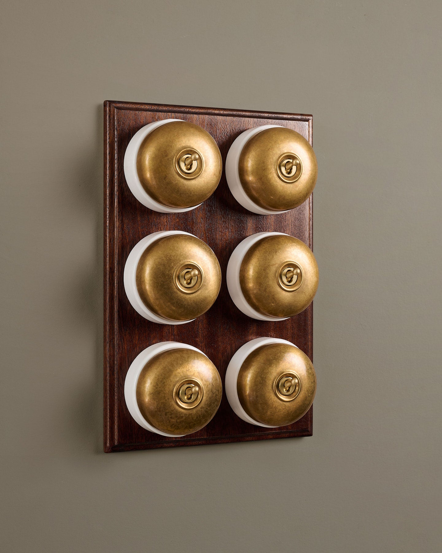The Dolly Toggle Switch (6 Gang & Mahogany Finish Pattress) - Aged Brass with White Base.