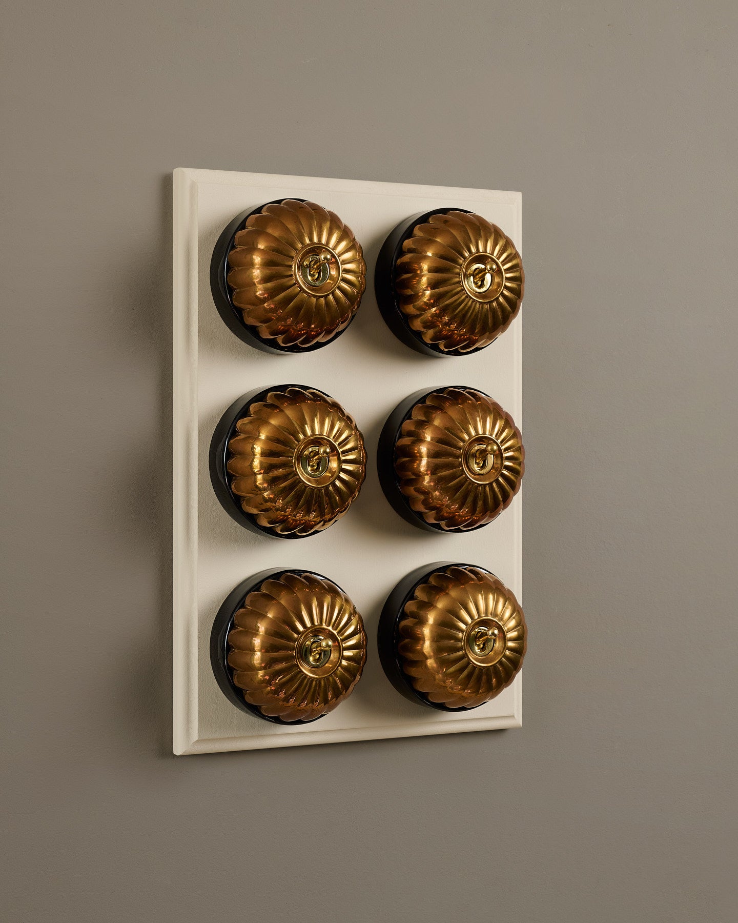The Jelly Toggle Switch (6 Gang & Primed Maple Pattress) - Heirloom Brass with Black Base.