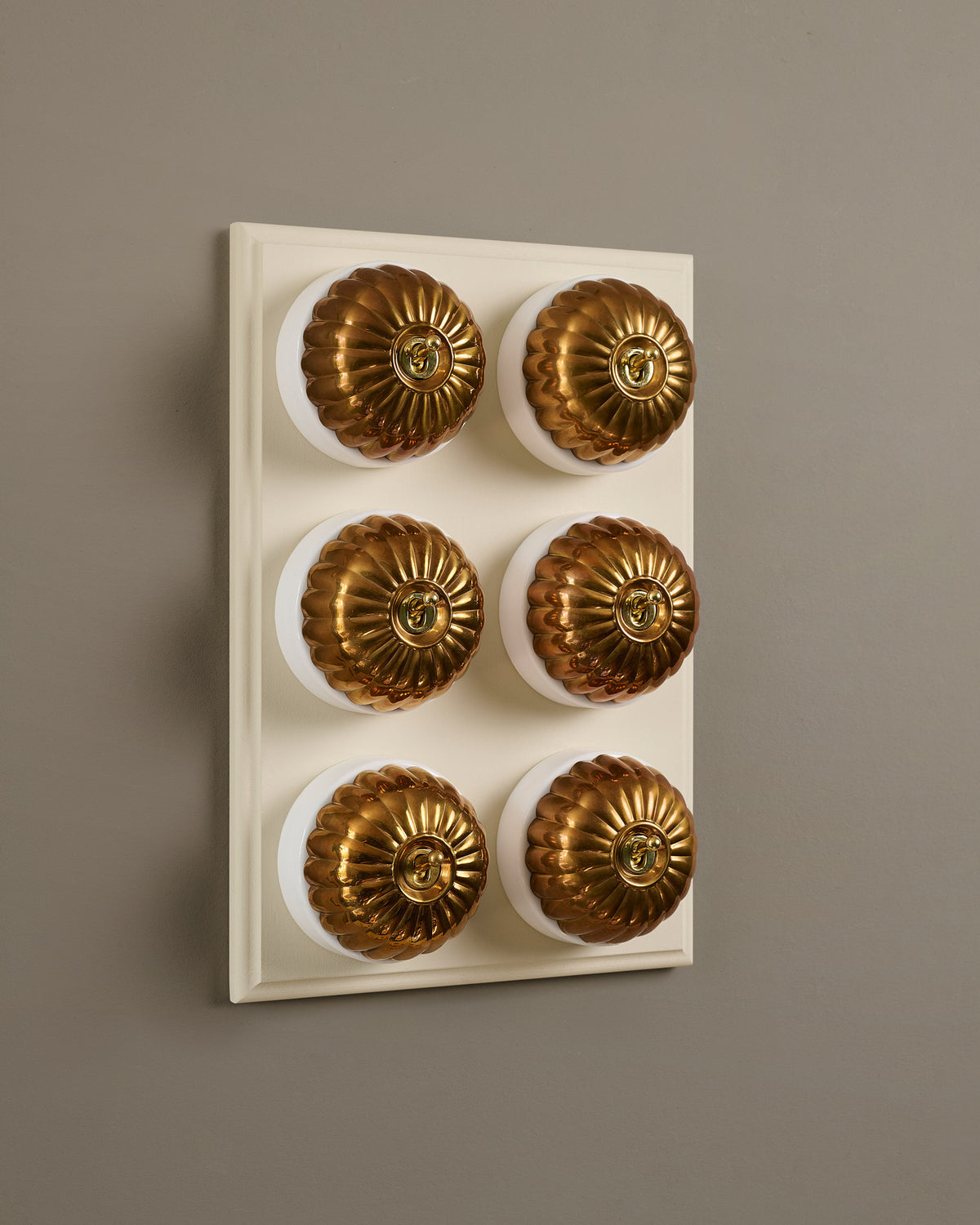 The Jelly Toggle Switch (6 Gang & Primed Maple Pattress) - Heirloom Brass with White Base. TEST