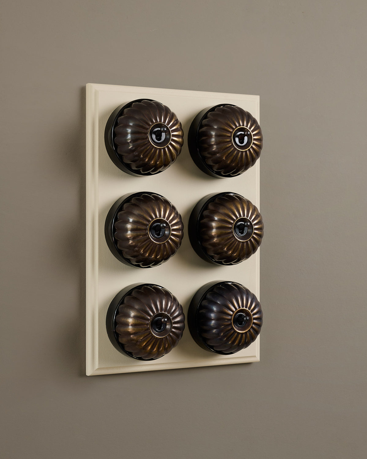 The Jelly Toggle Switch (6 Gang & Primed Maple Pattress) - Oxidised Brass with Black Base. TEST
