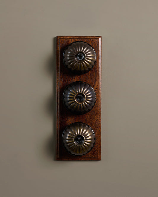 The Jelly Toggle Switch (3 Gang & Mahogany Finish Pattress) - Oxidised Brass with Black Base.