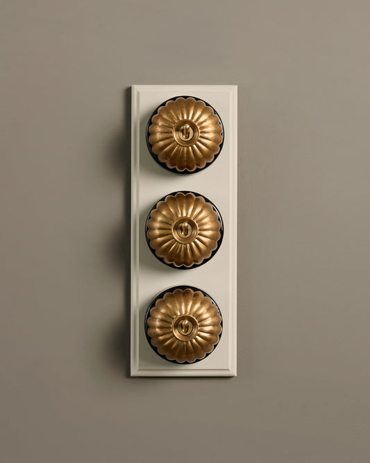 The Jelly Toggle Switch (3 Gang & Primed Maple Pattress) - Aged Brass with Black Base.