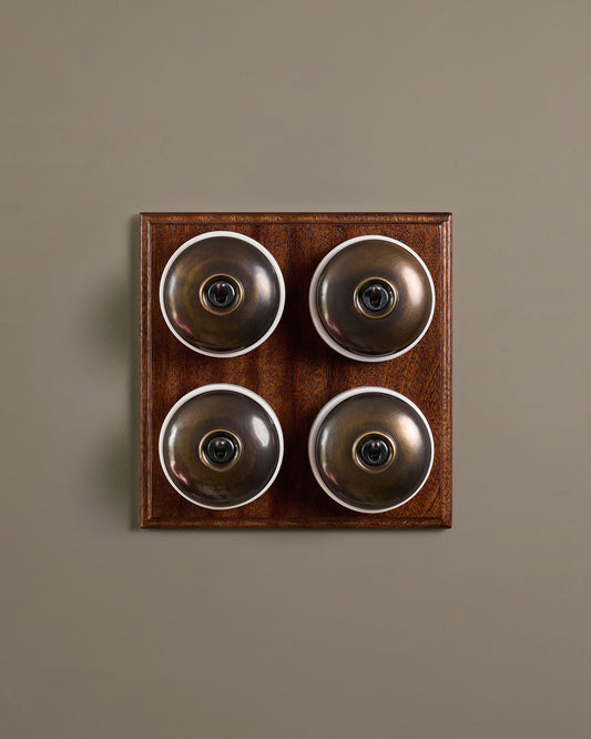 The Dolly Toggle Switch (4 Gang Bank & Mahogany Finish Pattress) - Oxidised Brass with White Base.