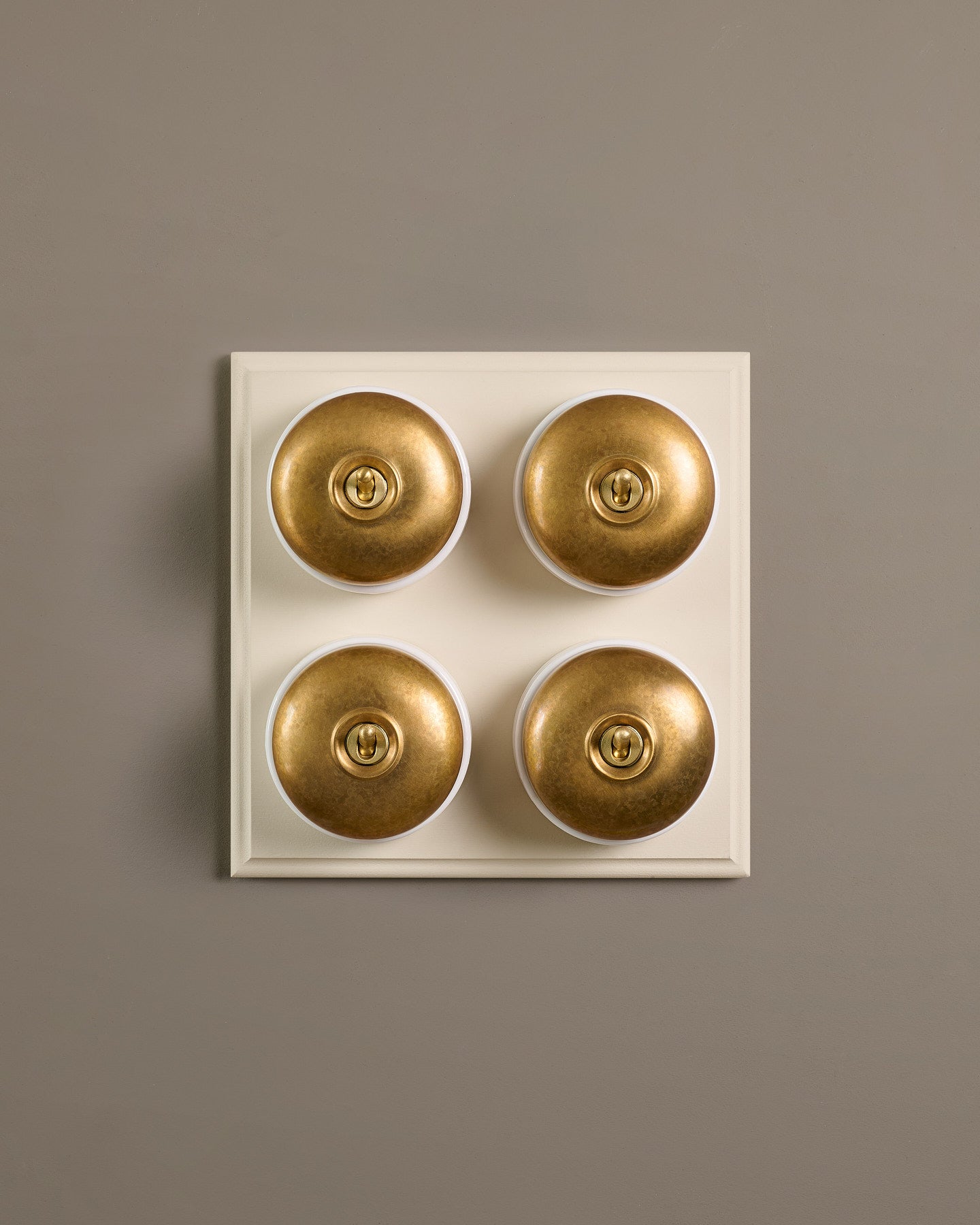 The Dolly Toggle Switch (4 Gang Bank & Primed Maple Pattress) - Aged Brass with White Base.