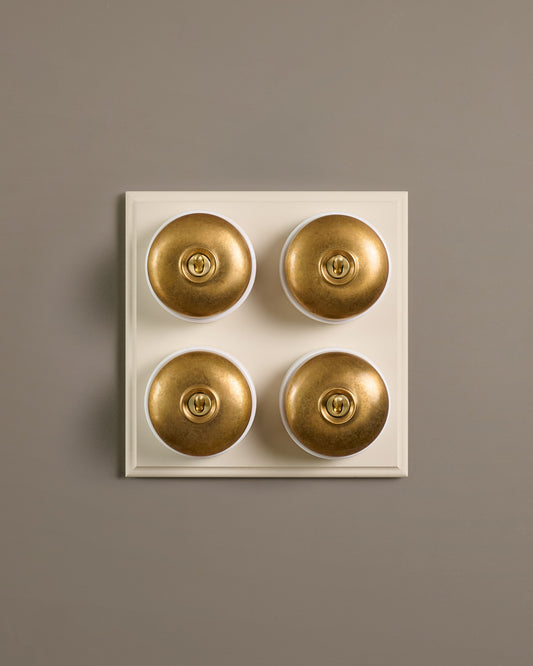 The Dolly Toggle Switch (4 Gang Bank & Primed Maple Pattress) - Aged Brass with White Base.