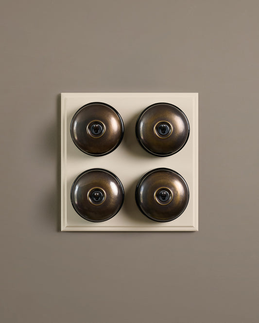 The Dolly Toggle Switch (4 Gang Bank & Primed Maple Pattress) - Oxidised Brass with Black Base.