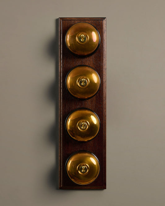 The Dolly Toggle Switch (4 Gang Row & Mahogany Finish Pattress) - Heirloom Brass with Black Base.
