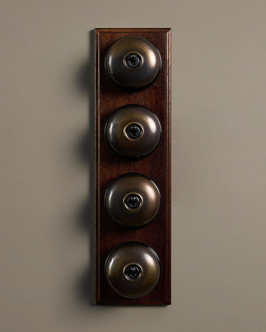The Dolly Toggle Switch (4 Gang Row & Mahogany Finish Pattress) - Oxidised Brass with Black Base.