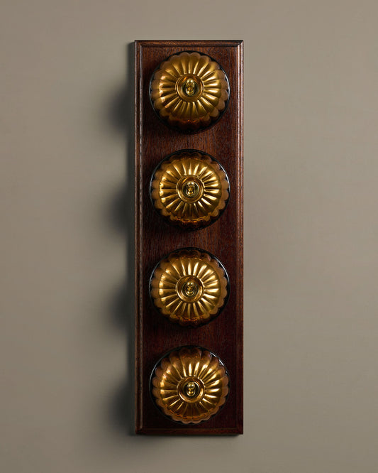 The Jelly Toggle Switch (4 Gang Row & Mahogany Finish Pattress) - Heirloom Brass with Black Base.