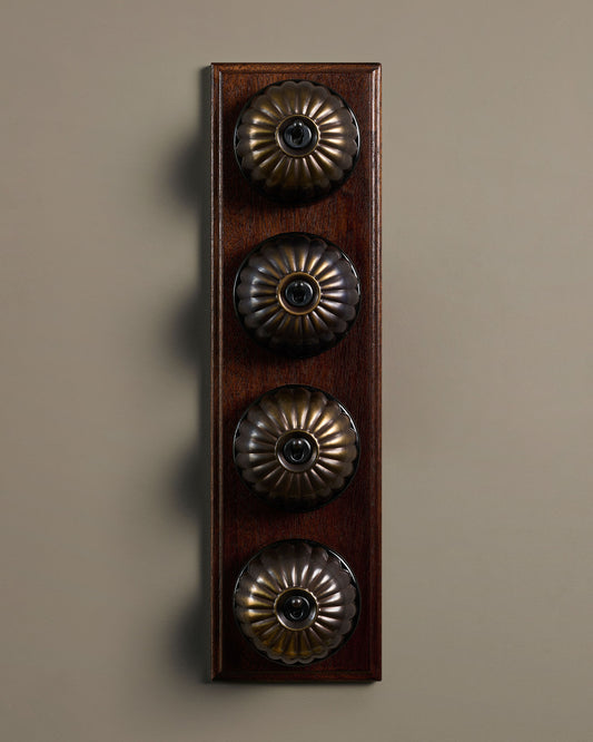 The Jelly Toggle Switch (4 Gang Row & Mahogany Finish Pattress) - Oxidised Brass with Black Base.