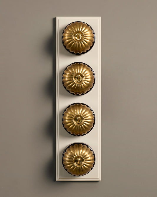 The Jelly Toggle Switch (4 Gang Row & Primed Maple Pattress) - Aged Brass with Black Base.