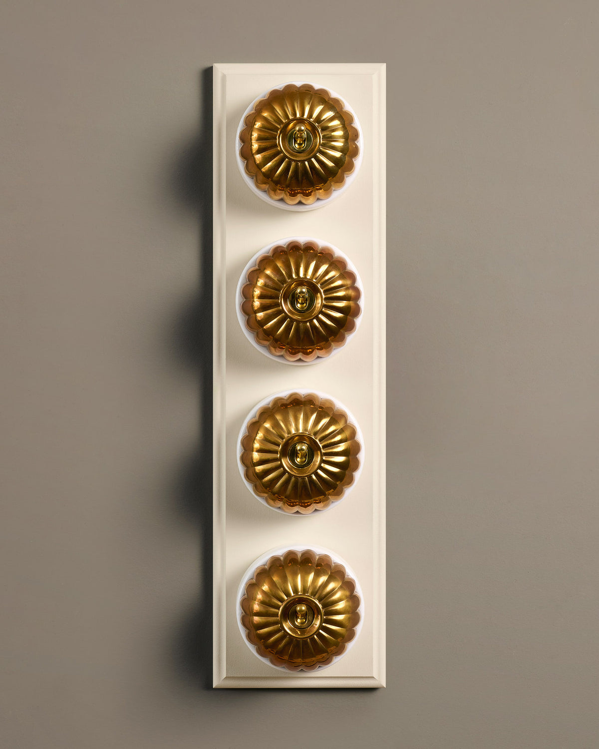 The Jelly Toggle Switch (4 Gang Row & Primed Maple Pattress) - Heirloom Brass with White Base. TEST