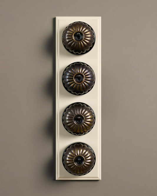 The Jelly Toggle Switch (4 Gang Row & Primed Maple Pattress) - Oxidised Brass with Black Base.