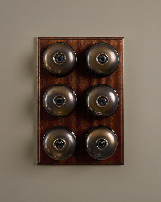 The Dolly Toggle Switch (6 Gang & Mahogany Finish Pattress) - Oxidised Brass with Black Base.