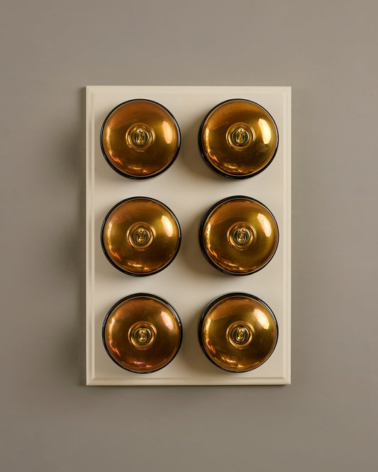 The Dolly Toggle Switch (6 Gang & Primed Maple Pattress) - Heirloom Brass with Black Base.