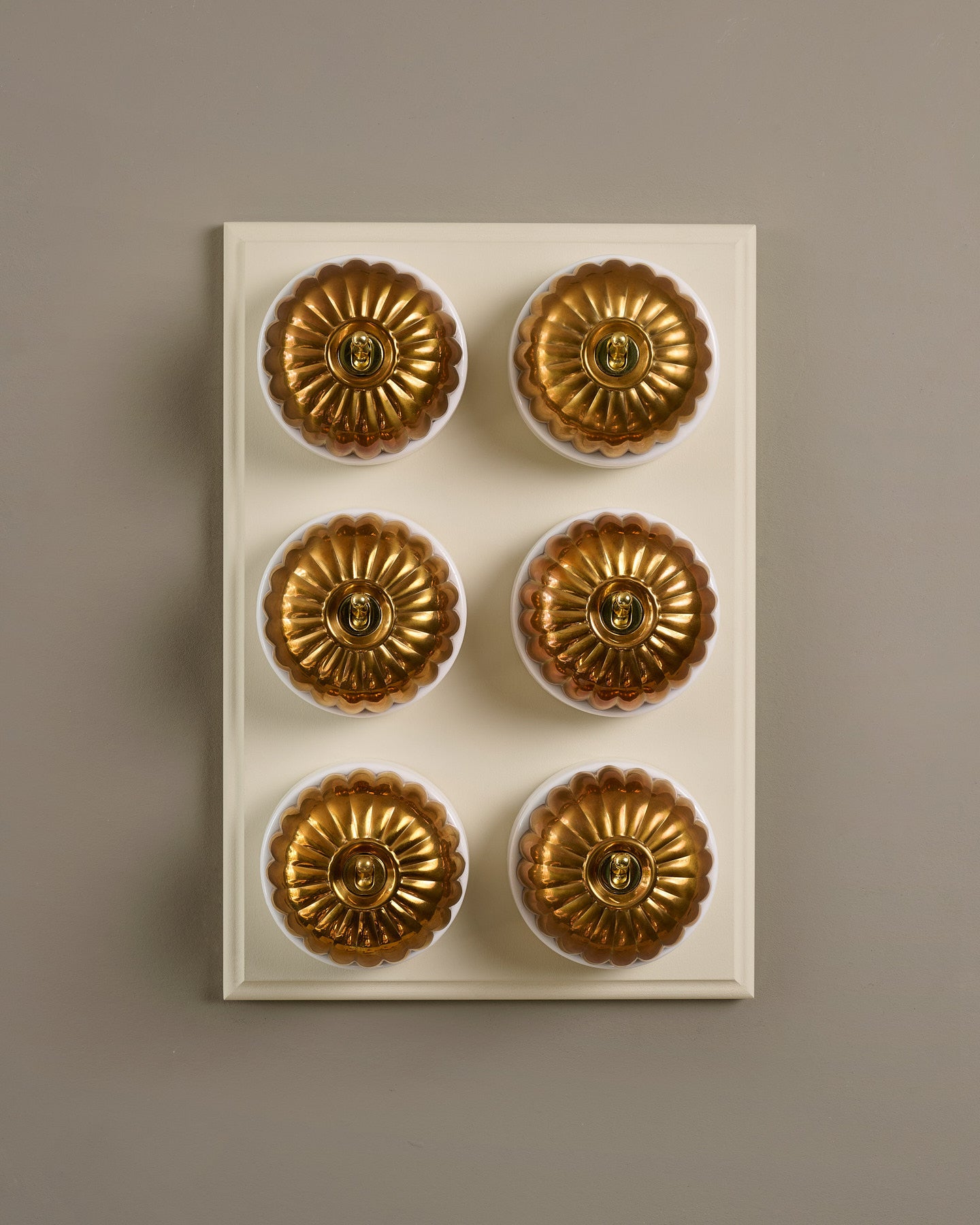 The Jelly Toggle Switch (6 Gang & Primed Maple Pattress) - Heirloom Brass with White Base.