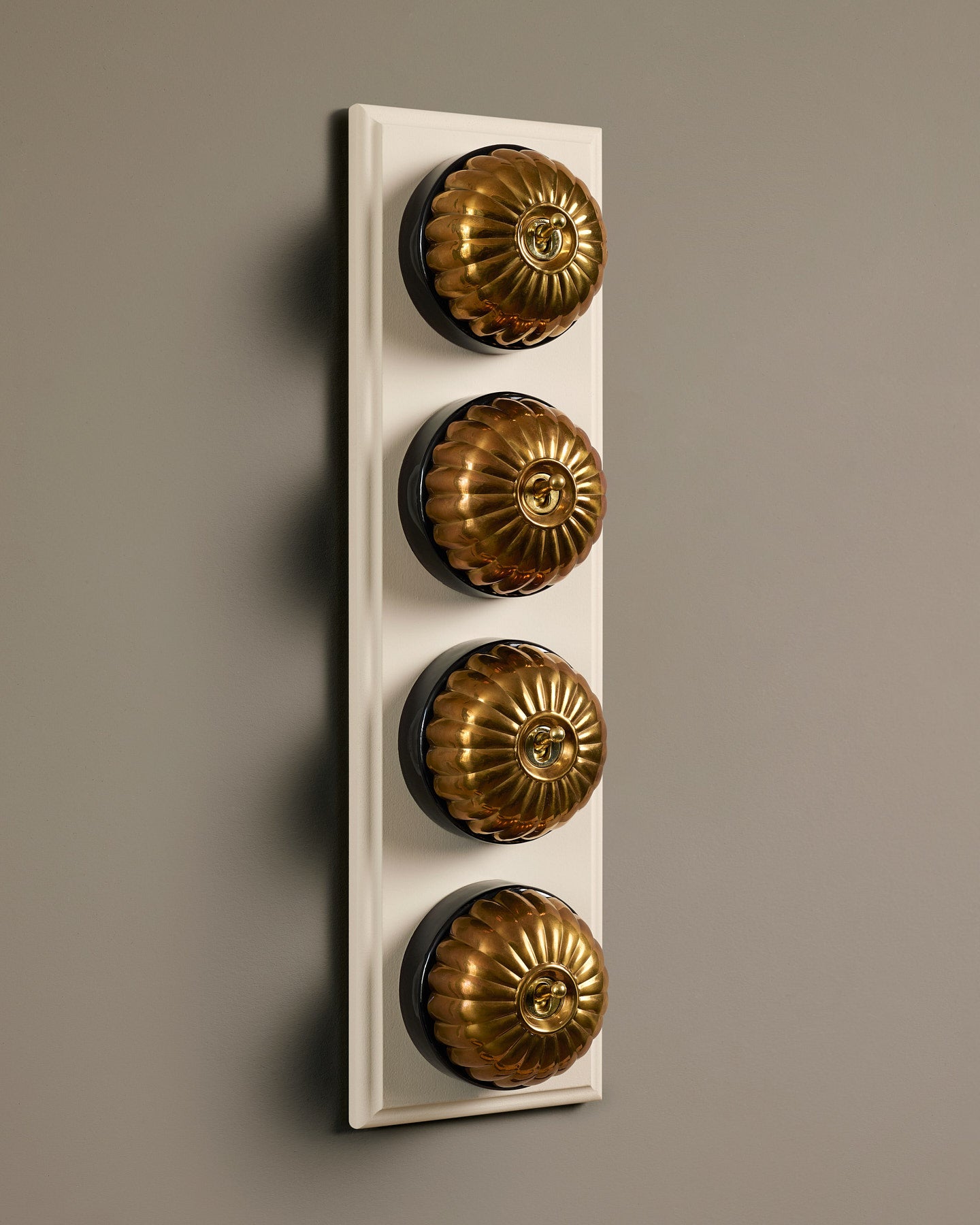 The Jelly Toggle Switch (4 Gang Row & Primed Maple Pattress) - Heirloom Brass with Black Base.