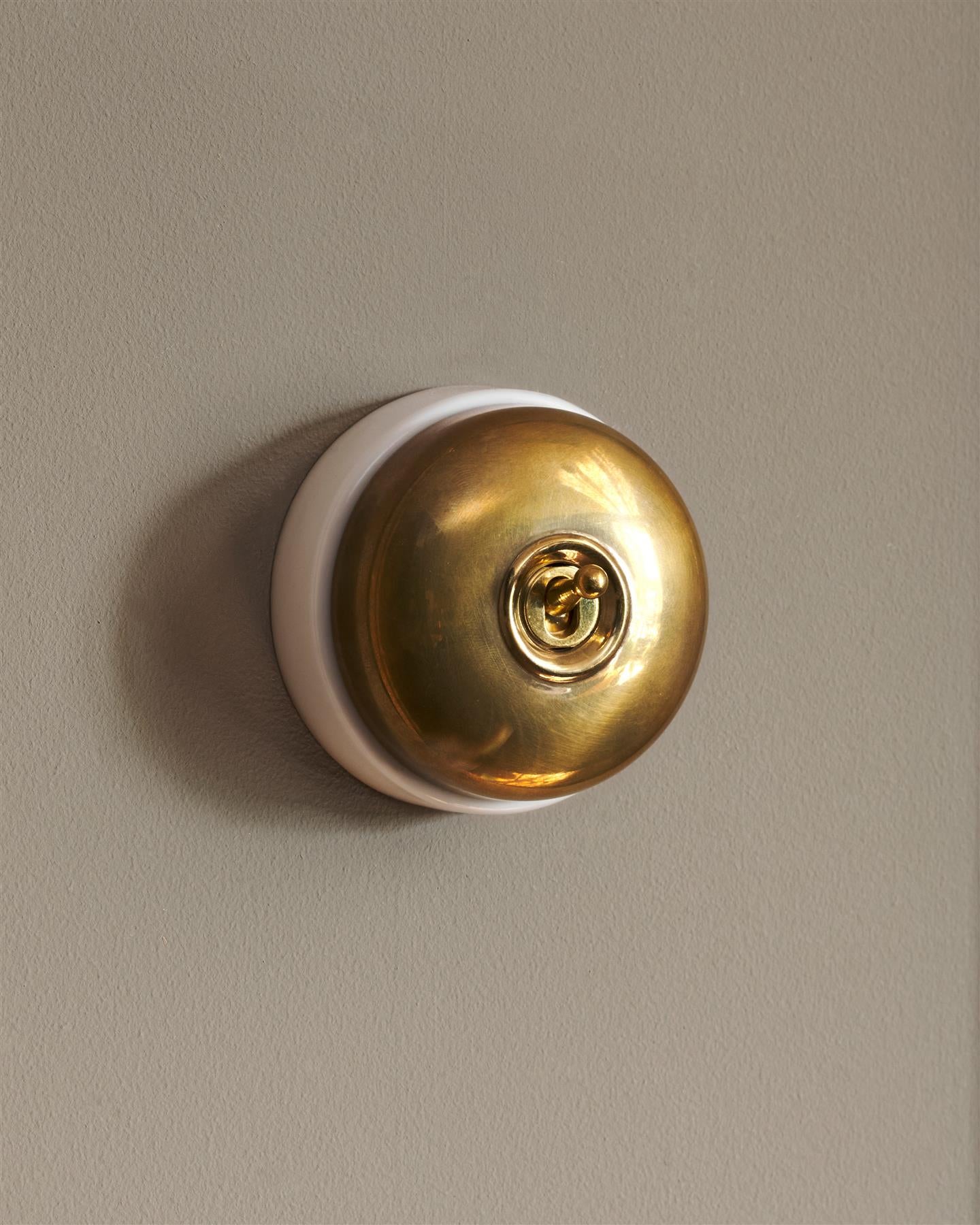 The Dolly Toggle Switch - Heirloom Brass, White Base, Single Way Retract