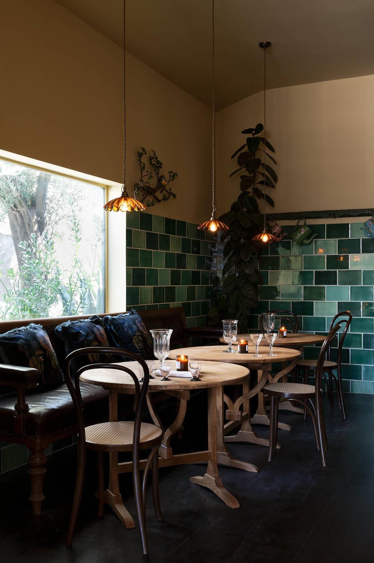 A front profile view of a cafÈ-style bar stool with a dark stained frame and light woven ratten seat.