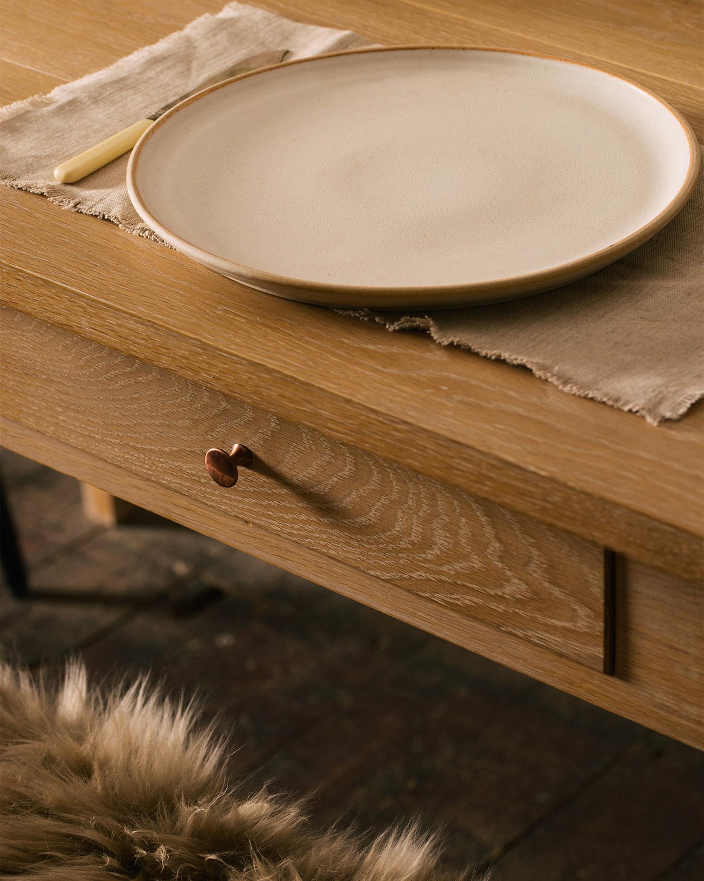 A close-up view of breadboard ends from an oak dining table.
