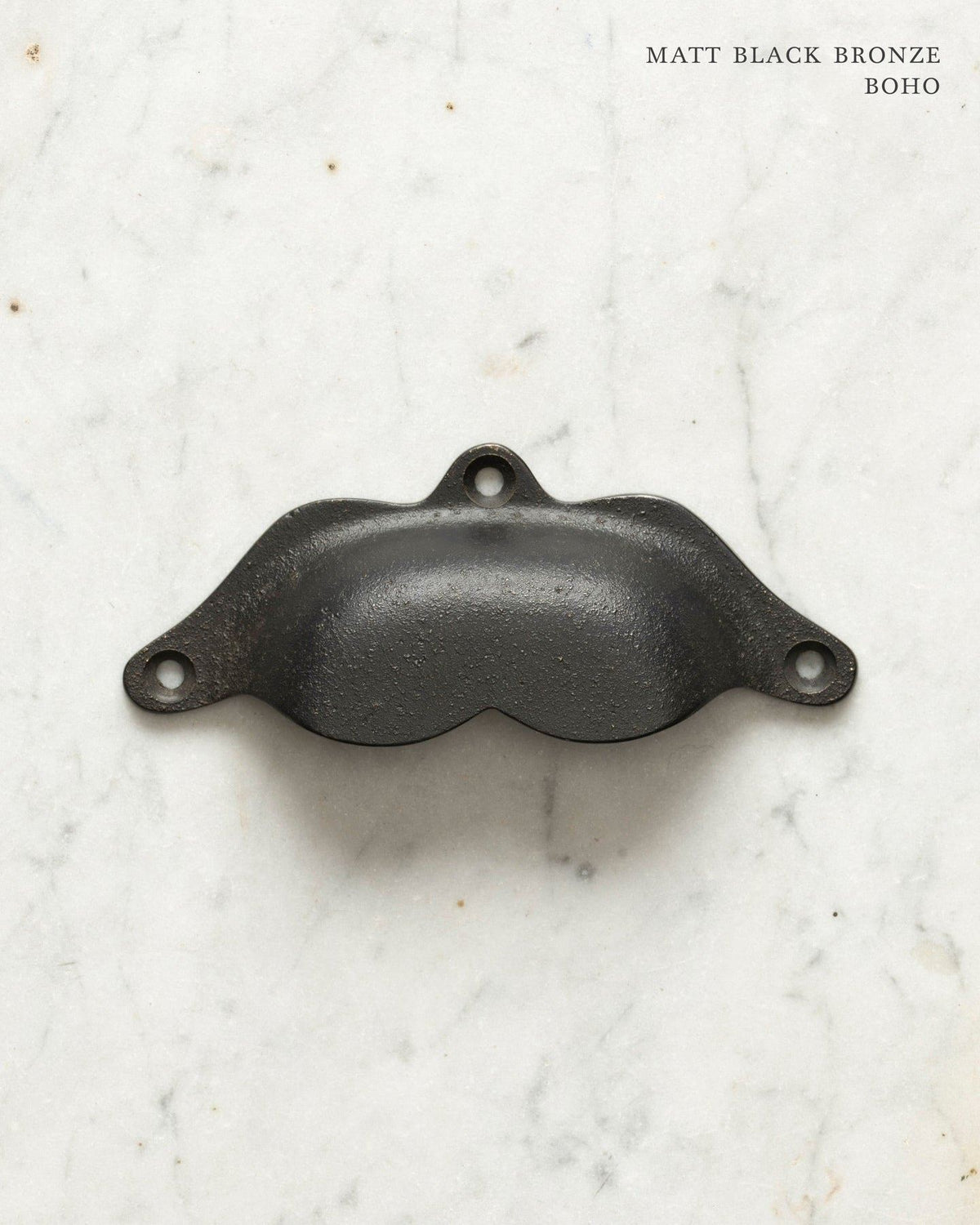 Two bohemian-style cup handles for a kitchen cupboard or drawer with a matt black bronze finish. There is a large and a small size. TEST