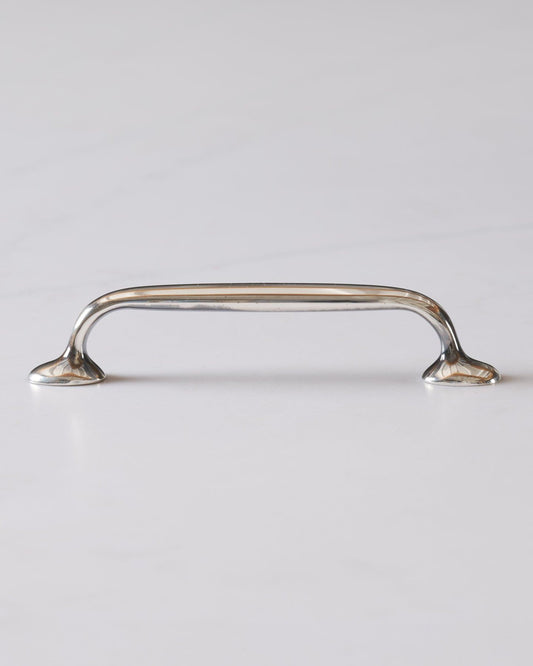 A profile view of a simple pull handle for a kitchen cupboard or drawer in a tarnished 'Bella' silver finish.
