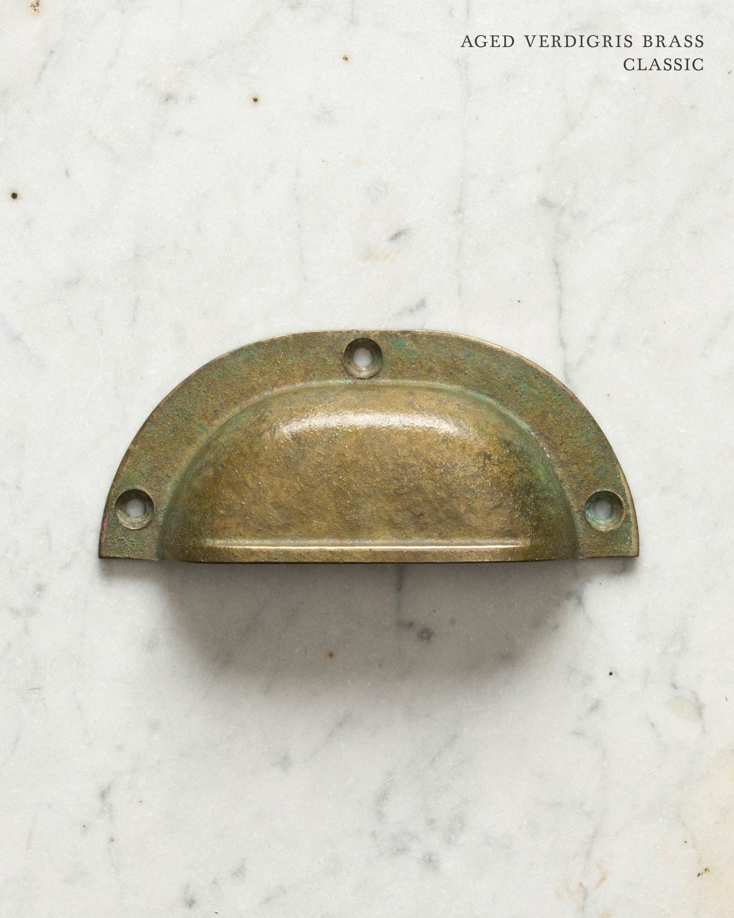Two classic cup handles for a kitchen cupboard or drawer with an aged verdigris brass finish. There is a large and a small size.