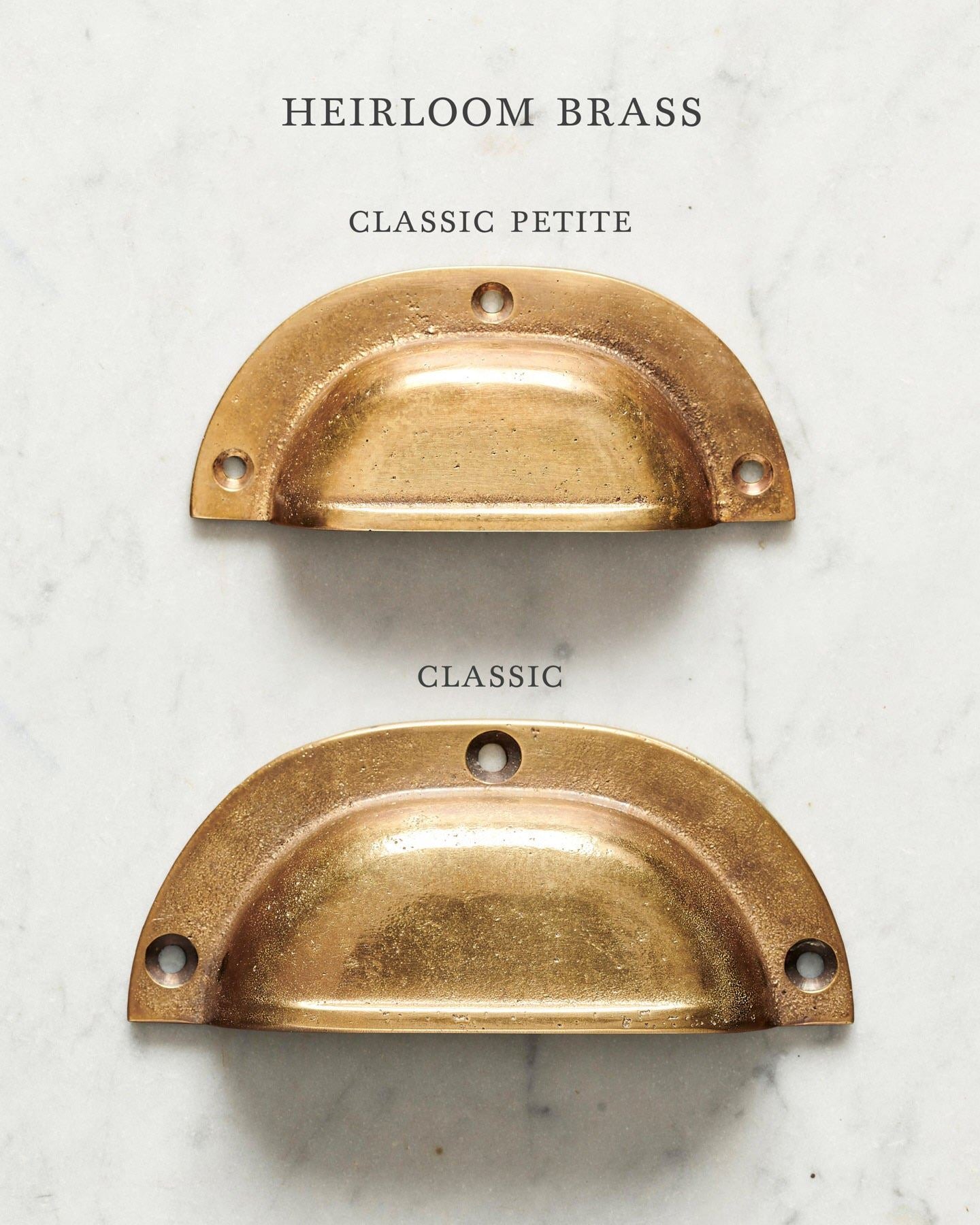 Two classic cup handles for a kitchen cupboard or drawer with a warm burnished brass finish. There is a large and a small size.