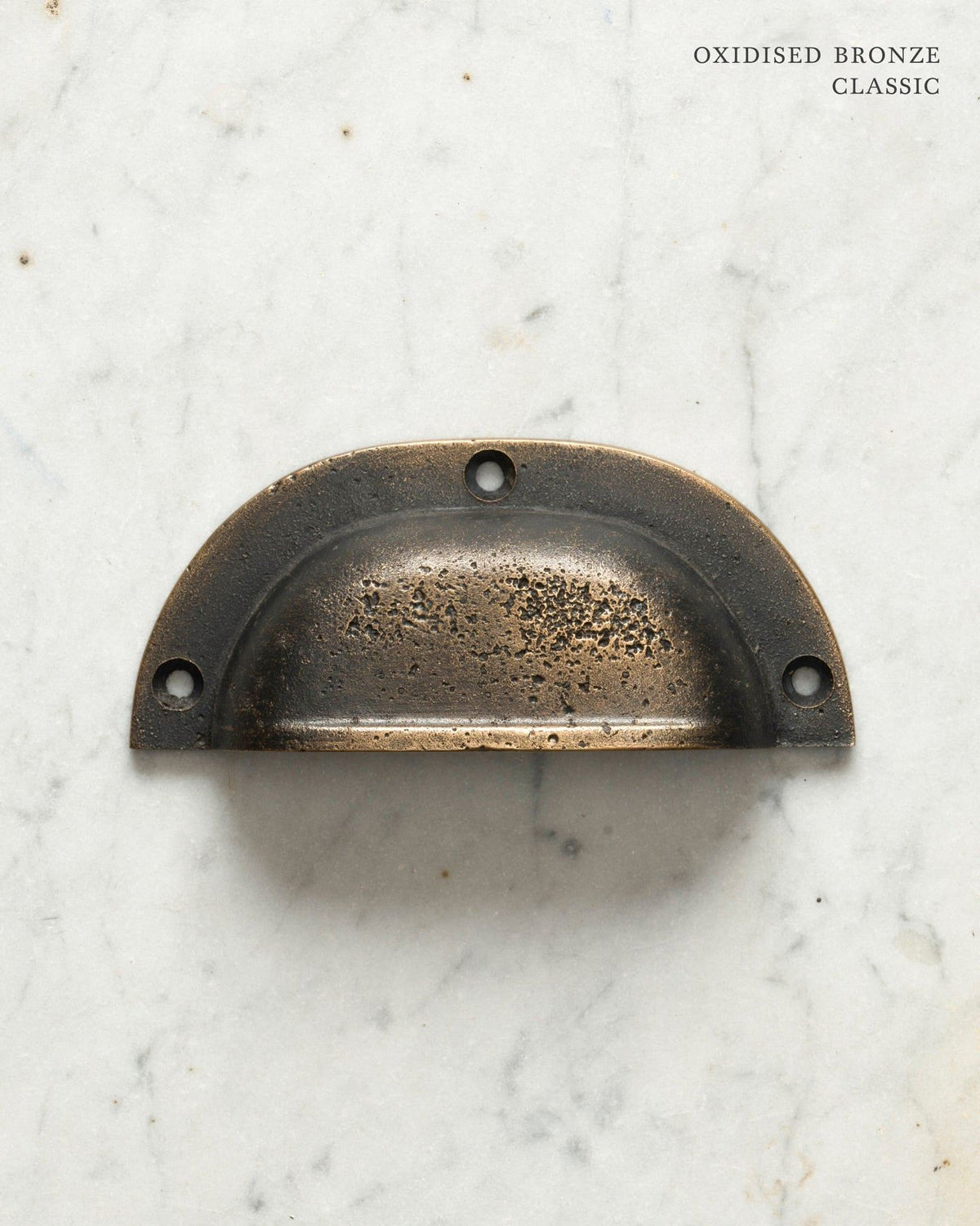 Two classic cup handles for a kitchen cupboard or drawer with a dark oxidised bronze finish. There is a large and a small size. TEST