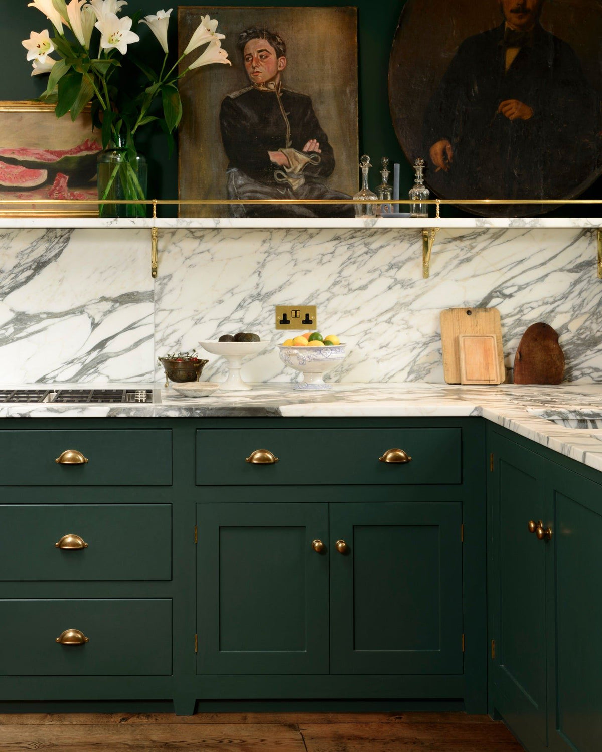 A straight-on view of a racing green painted Georgian-style kitchen with simple cup handles and round doorknobs in a burnished 'Bella' brass finish. TEST