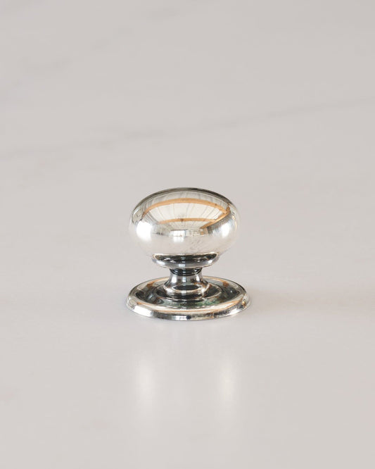 A 'Small' round doorknob with a pressed backplate for a kitchen cupboard or drawer in a tarnished silver finish.