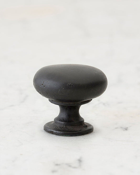 A 'Large' classic knob for a kitchen cupboard or drawer with a matt black bronze finish that makes it look like a beloved, well aged brass from centuries ago.
