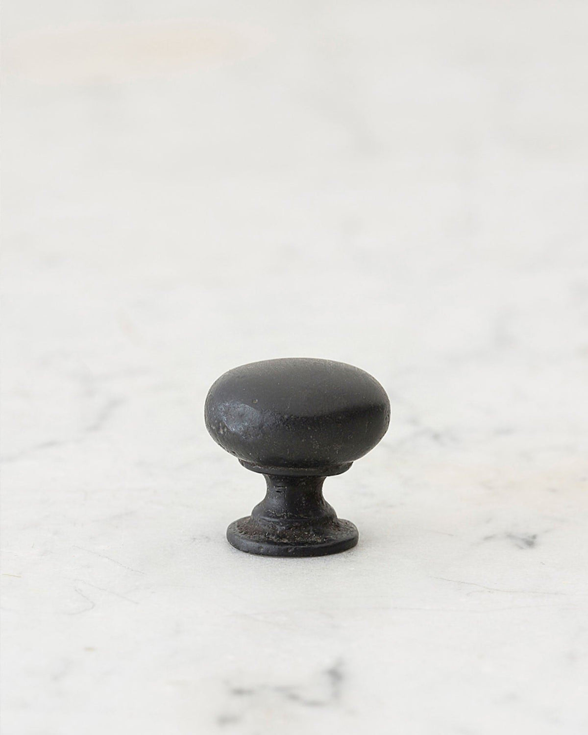 A 'Petite' classic knob for a kitchen cupboard or drawer with a matt black bronze finish that makes it look like a beloved, well aged brass from centuries ago. TEST