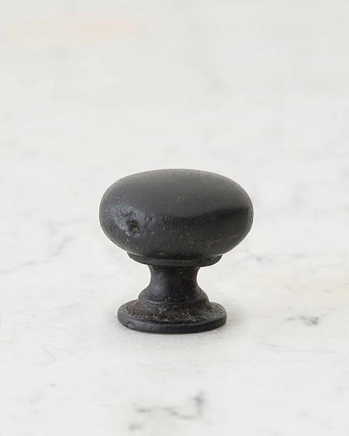 A 'Medium' classic knob for a kitchen cupboard or drawer with a matt black bronze finish that makes it look like a beloved, well aged brass from centuries ago.
