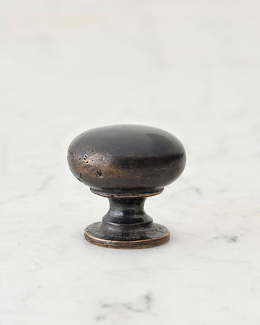 A 'Medium' classic knob for a kitchen cupboard or drawer with a dark oxidised bronze finish and unique dented textures as if was made by an artisan blacksmith centuries ago.