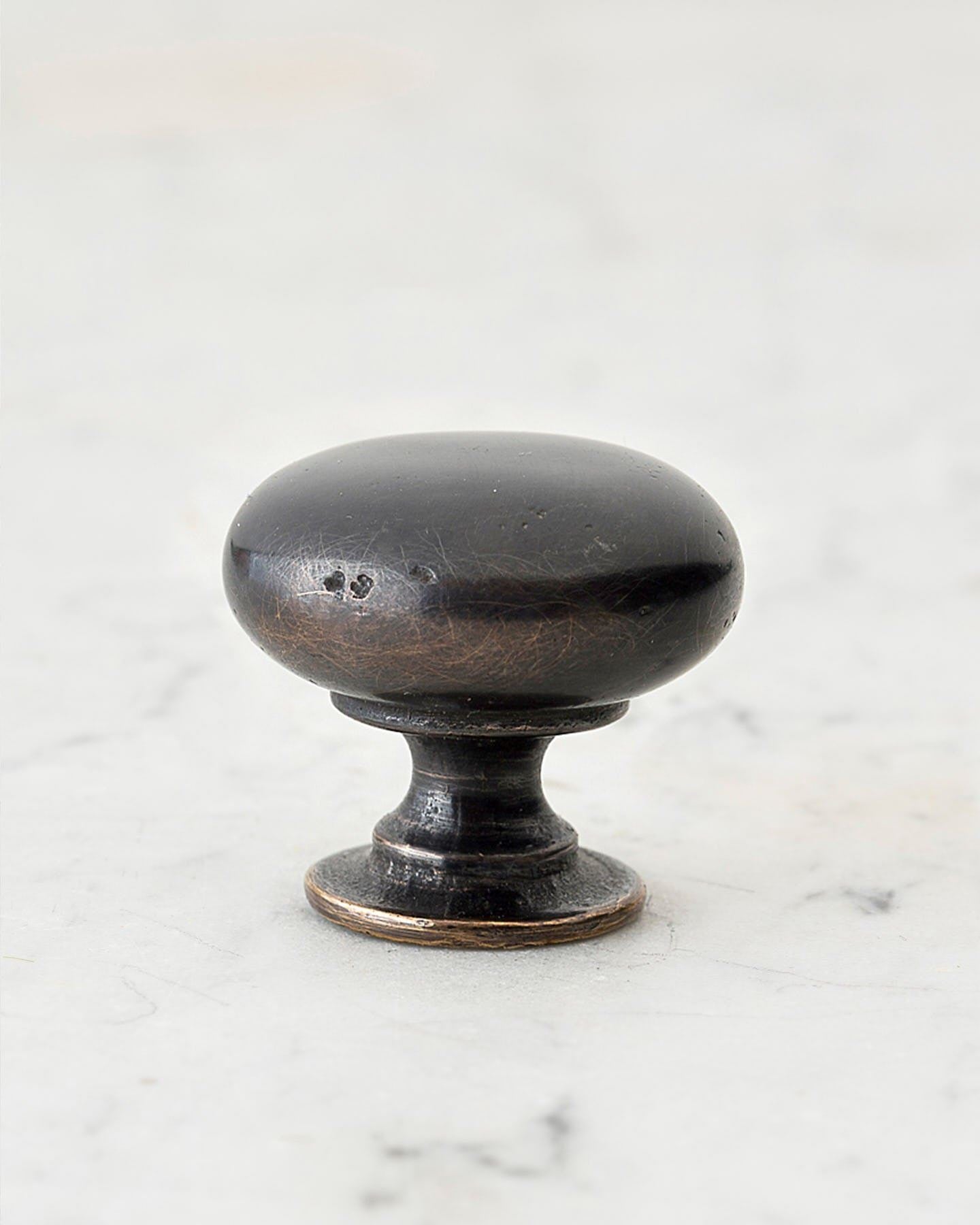 A 'Large' classic knob for a kitchen cupboard or drawer with a dark oxidised bronze finish and unique dented textures as if was made by an artisan blacksmith centuries ago.