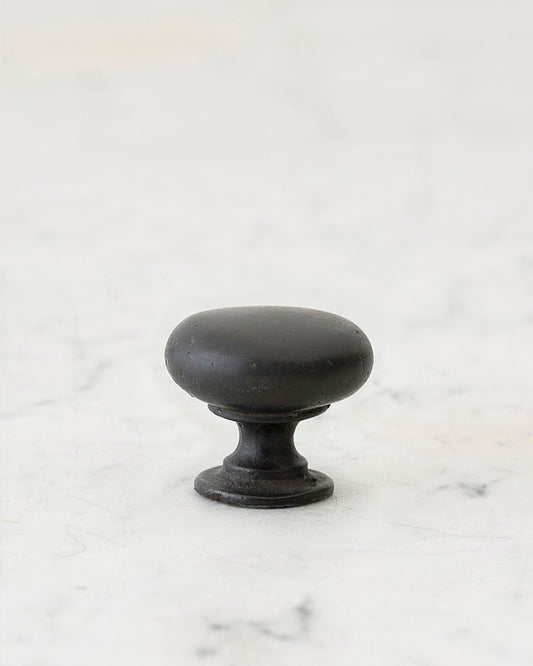 A 'Small' classic knob for a kitchen cupboard or drawer with a matt black bronze finish that makes it look like a beloved, well aged brass from centuries ago.