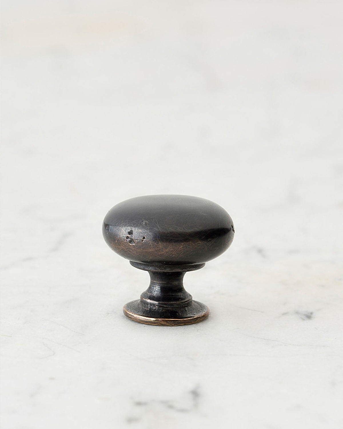 A 'Small' classic knob for a kitchen cupboard or drawer with a dark oxidised bronze finish and unique dented textures as if was made by an artisan blacksmith centuries ago. TEST