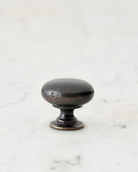 A 'Small' classic knob for a kitchen cupboard or drawer with a dark oxidised bronze finish and unique dented textures as if was made by an artisan blacksmith centuries ago.