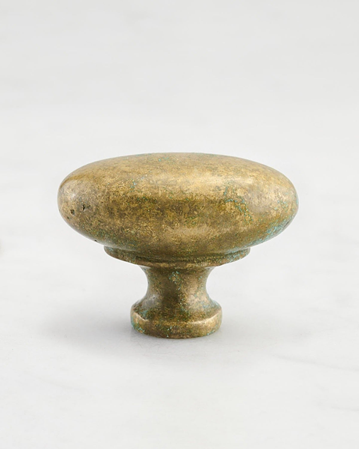 A 'Large' oval-shaped knob for a kitchen cupboard or drawer with an aged verdigris brass finish and unique dented textures as if was made by an artisan blacksmith centuries ago. TEST